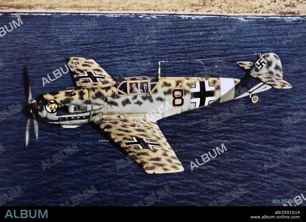 Photograph of a Messerschmitt Bf 109, a German World War II fighter aircraft, flying over Africa. Dated 20th Century.