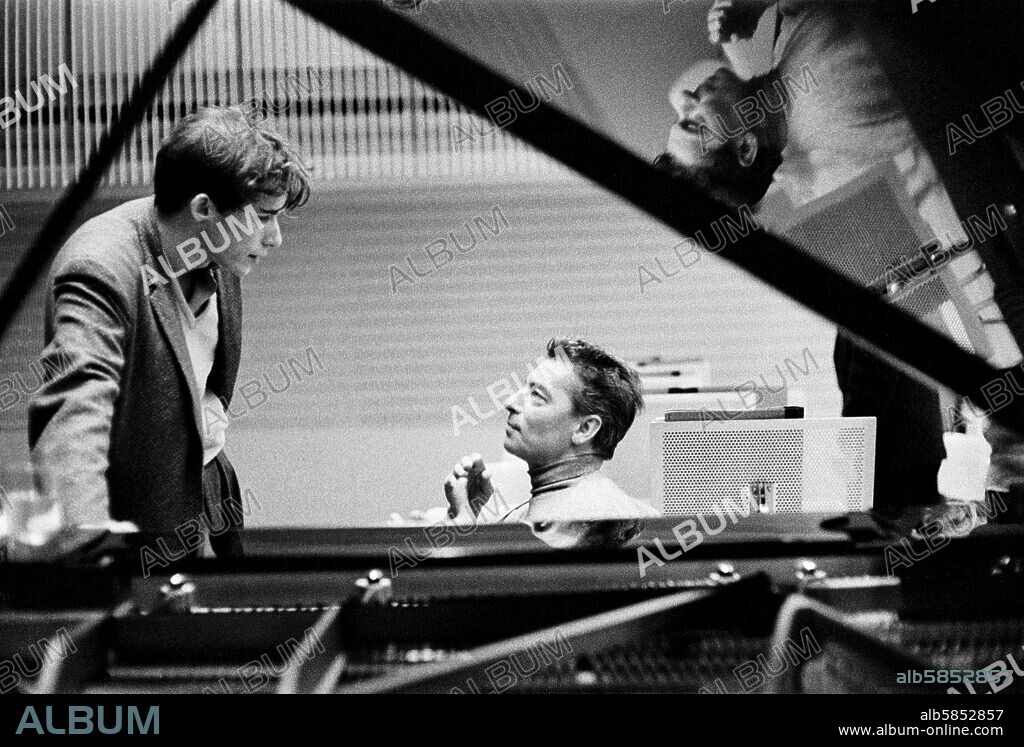 ERICH LESSING. Conductor Herbert von Karajan (5.4.1908 - 16.7.1989) recording Beethoven's Piano Concerto No. 3 in C minor, Op. 37 with the Berlin Philharmonic and the pianist Glenn Gould. 
Concert Hall of the Hochschule der Kuenste, Berlin, Germany, 24 to 26 May 1957.