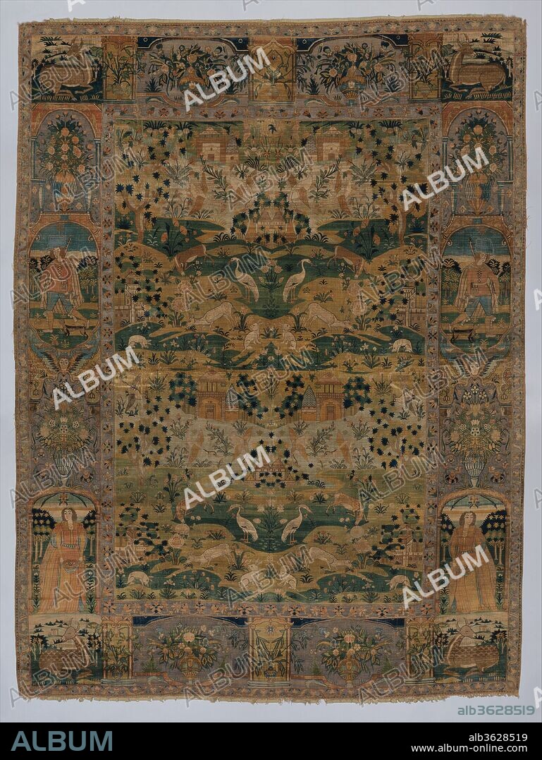 Pictorial Carpet. Dimensions: Rug: L. 91 1/2 in. (23.4 cm)
 W. 68 in. (172.7 cm)67.2.2
Rug: L. 91 1/2 in. (23.4 cm)
 W. 68 in. (172.7 cm)
Tube: Diam. 6 1/2 in. (16.5 cm)
W. 82 in. (208.3 cm). Date: 17th century.
This silk carpet combines an unusually dense weave for a Persian carpet, with a composition inspired by Flemish tapestry. While the pictorial scene can be traced to seventeenth-century Europe, the technique and execution point to the Safavid court as the source of patronage and production. It is possible that such carpets were woven in Iran for export or intended as diplomatic gifts. The smaller scale of the buildings suggests the influence of European perspective. The border compartments, whose arrangement is also repeated symmetrically, show figures in European dress, flower vases, and reclining deer.