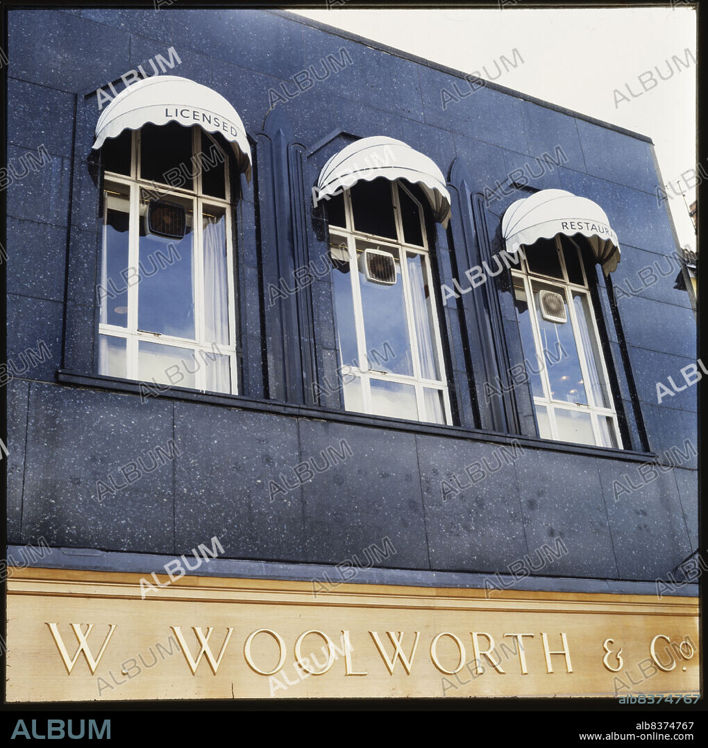 NICHOLAS ANTHONY JOHN PHILPOT. FW Woolworth and Co Ltd, 8-9 Bridge Street, Stratford-upon-Avon, Warwickshire, 1970s-1980s. The first floor windows and the granite facade of F W Woolworth & Co Ltd at 8-9 Bridge Street, originally built as a Burton store. The Burton store on Bridge Street was built in 1937; a foundation stone was laid by Raymond Montague Burton. Granite facades feature on around 15 Burton stores, including Stratford-upon-Avon, Kingston-upon-Hull, and Reading. The suppliers of the granite may have been Fenning & Co of Hammersmith.