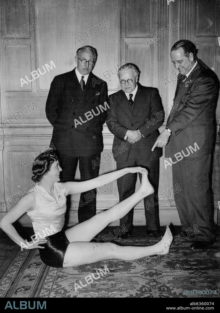 Minister Of Health Attends Health No Beauty Demonstration -- (L to R) Sir Edward Campbell, M.P., Sir Kingsley Wood and Sir Noel Curtis Bennett, K.C. watching Prunella Stack giving a demonstration.Prunella Stack and members of the Women's League of health and beauty cave a demonstration at the Hotel Metropole this evening, attended by Sir Kingsley Wood, Minister of Health. March 9, 1938. (Photo by Keystone).