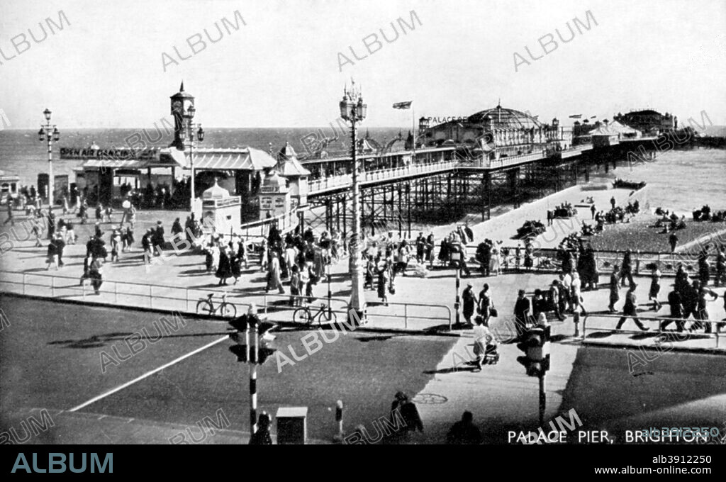 Palace Pier, Brighton, Sussex, early 20th century. Brighton's Palace Pier was opened in grand ceremony on 20 May 1899. By 1901, the pier consisted of a building with minaret corner towers housing dining, smoking and reading rooms and its first concert hall. 21 years elapsed before the next major phase saw the addition of a big wheel, heralding an extension to the pier's length and a widening of the promenade. In 1984, the pier was revitalised under new ownership. At 1722 ft long, Brighton Pier, a Grade 2* listed building, is acknowledged as the finest pier ever built.