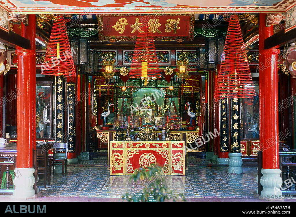 Phuc Kien is the Vietnamese for Fujian, and this, the richest of the several Chinese Assembly Halls in Hoi An, was founded by merchants from Fujian Province. It also serves as a temple dedicated to Thien Hau, a goddess who specially cares for seafarers like the Fujian merchants in times past. The small temple complex is set back from the street beyond a courtyard. Here the Sea Goddess Thien Hau presides at the centre of the main altar in the first chamber. Her attendants on either side inform her whenever there is a shipwreck, so that she can intercede on the part of the mariners. To the right of the altar is a large model of a Chinese sailing junk. In the chamber at the back, another altar honours six seated figures representing the founding fathers of Hoi Ans Fujian community, who fled to Vietnam after the overthrow of the Ming Dynasty in 1644. The small but historic town of Ho An is located on the Thu Bon River 30km (18 miles) south of Danang. During the time of the Nguyen Lords (1558 - 1777) and even under the first Nguyen Emperors, Hoi An - then known as Faifo - was an important port, visited regularly by shipping from Europe and all over the East. By the late 19th Century the silting up of the Thu Bon River and the development of nearby Danang had combined to make Hoi An into a backwater. This obscurity saved the town from serious fighting during the wars with France and the USA, so that at the time of reunification in 1975 it was a forgotten and impoverished fishing port lost in a time warp.