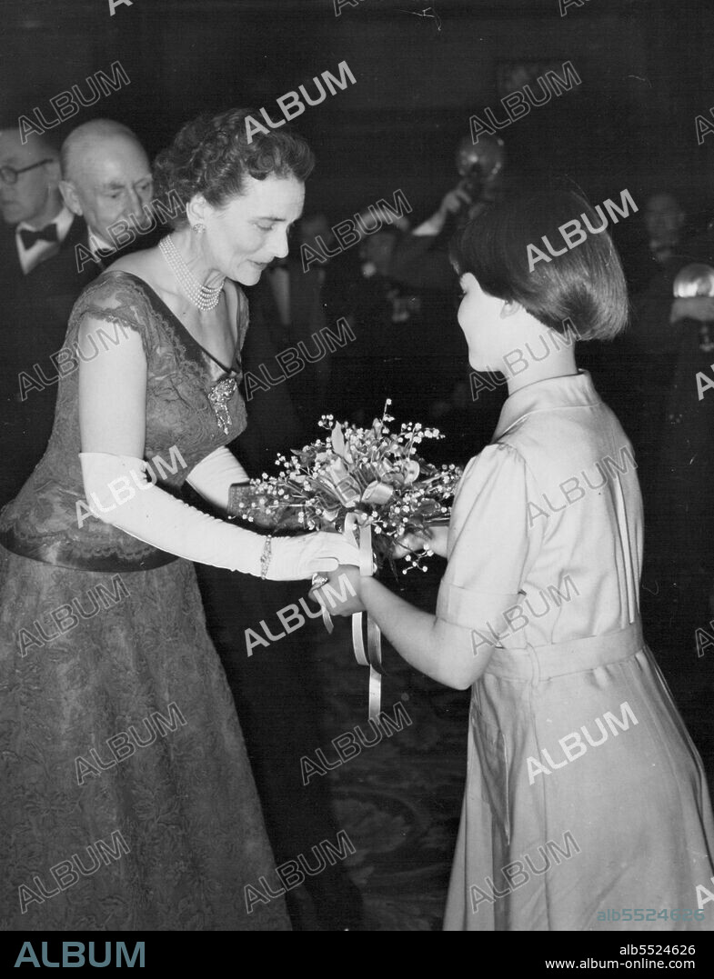 The Duke and Duchess of Gloucester attended a repeat Premiere on London on Monday evening of "The Dam Busters" the Story of famous R.A.F. pilot Guy Gibson V.C. Here the Duchess is being presented with a bouquet at the Premiere by 11½-year-old Vyvyan Denzy. May 19, 1955. (Photo by Evening Standard Picture).
