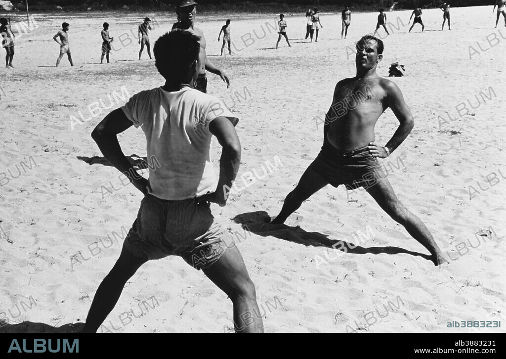 A U.S. Navy instructor gives Vietnamese students individual physical training as part of the course in which qualification for assignment to the Vietnamese junk force is attained. This junk force maintains surveillance over the Viet Cong fleet. circa 1960-1969.