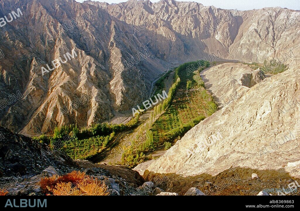 Located about 7km northeast of Korla, the ancient strongpoint of Tiemenguan or 'Iron Gate' is set amid incredibly barren, harsh and crumbling mountains. Its possible to understand the immense strategic significance of the Iron Gate pass by climbing the 1,497 steps to the summit.<br/><br/>. Here the tomb of the lovers Tzuhola and Tayir is set high above the narrow defile that once channelled the old Silk Road between two massive and impassable rocky outcrops. A small path winds by a stream, far below nowadays all but unused, but for at least two millennia a narrow artery for men, good and camels passing between east and west.<br/><br/>. Because of its strategic location controlling the Silk Road as it passed south of the Tian Shan and into the Tarim Basin, Tiemenguan was easily defended by garrison troops and almost impossible for merchants and other travellers to avoid.<br/><br/>. For Uighurs the narrow pass is associated with tragedy in love. Long ago Tzuhola, a Uighur princess, fell in love with Tayir, a simple shepherd. Her father, the king, had intended the princess to marry a prince, and was greatly displeased. The two lovers fled into the mountains pursued by the kings troops, who had orders to bring them back. They fell to their deaths near Tiemenguan and the king, who was heartbroken, ordered the building of a twin tomb so they could be together in the afterlife. A statue of the two lovers in flight on horseback has recently been erected near the tomb.