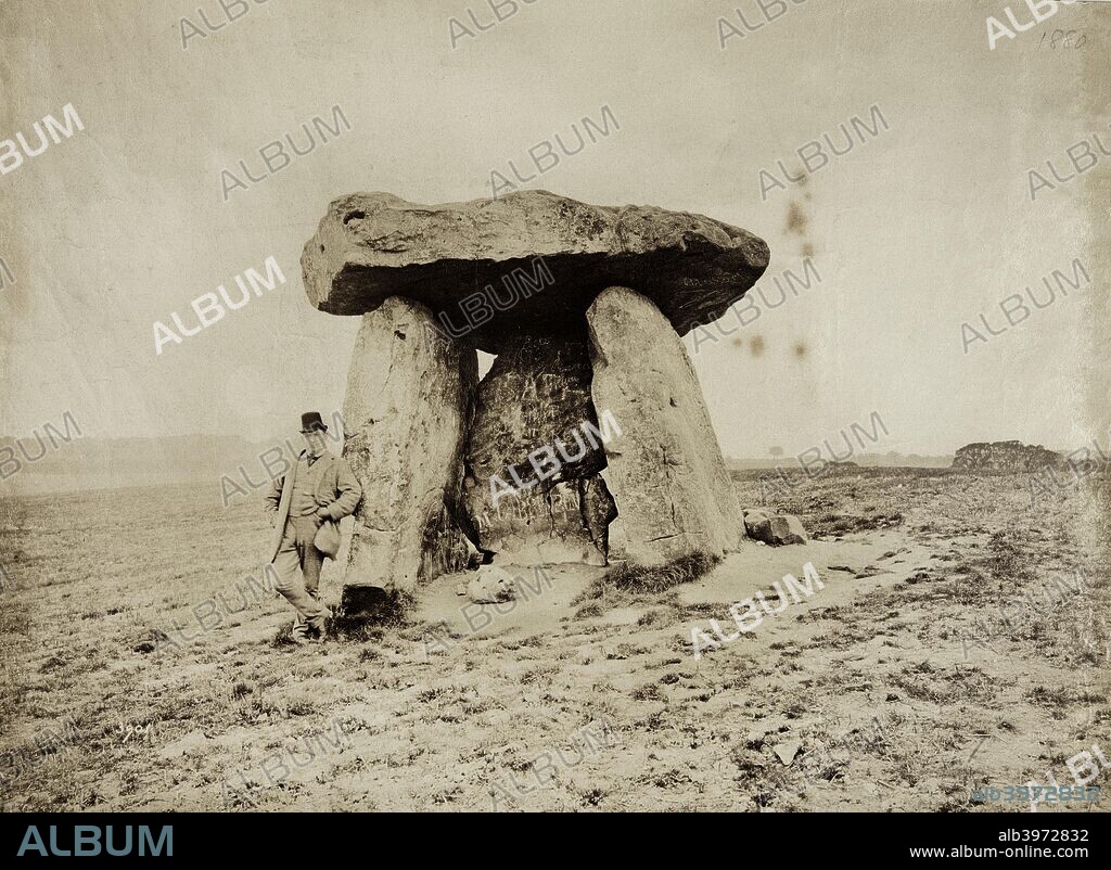 Kit's Coty House, Aylesford, Kent, 1880. Albumen print. Flaxman Spurrell's photograph album contains two photographs of Kit's Coty House, the remains of a Neolithic long barrow and burial chamber. The first one, taken in 1880 and seen here, shows the monument before the Ancient Monuments Protection Act in 1882 that recognised the need for a Government role in safeguarding the nation's ancient monuments. The second, which Spurrell captioned 'Kit's Coty under The Act', was taken in 1888 and clearly shows the iron railings which now restricted public access and prevented further damage to the monument. Graffiti scratched into an upright and worn ground around the monument are evident in Spurrell's photographs.