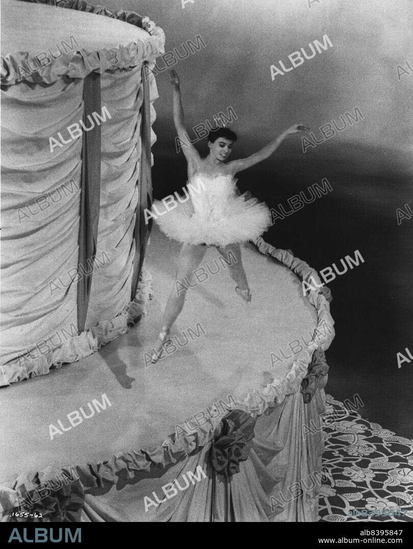 Gay Ballerina...is Leslie Caron, as she appears in a highlight ballet sequence in M-G-M's "The Glass Slipper", co-starring Michael Wilding. Dancers of Roland Petit's Ballet de Paris appear in the ballet sequence with the two stars. Charles Walters directed the new film, produced in color by Edwin H. Knopf. Keenan Wynn, Estelle Winwood, Barry Jones and Elsa Lanchester also head the cast. March 12, 1955.