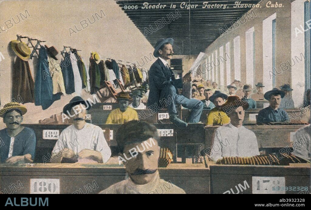 Reader in Cigar Factory, Havana, Cuba. Readers are a traditional feature of Cuban cigar factories where the reader, often someone with radio experience, reads the news, stories or soap operas while the workers are busy rolling cigars. [Harris Bros. Co., Havana, Cuba].