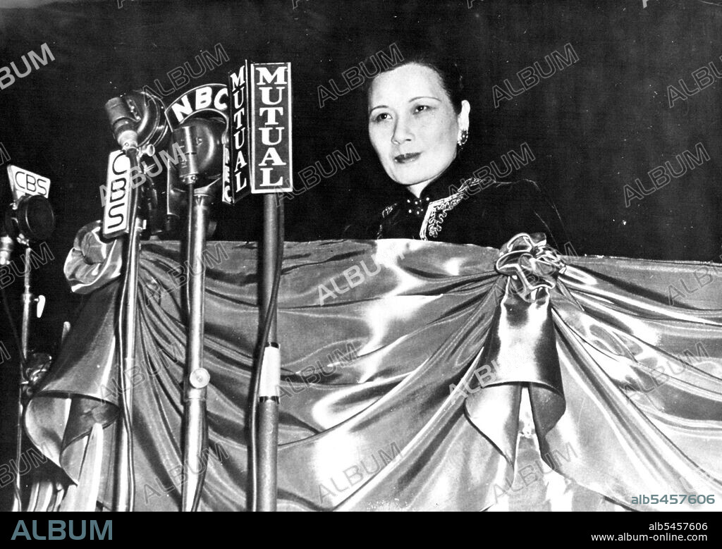 Madame Chiang Kai-Shek Addresses The American People -- Madame Chiang Kai-Shek, standing before a barrage of microphones on the speakers' stand at Madison Square Garden, addresses the thousands who appeared to honor her arrival in New York City. Her address was also heard all over America by radio. April 21, 1943.