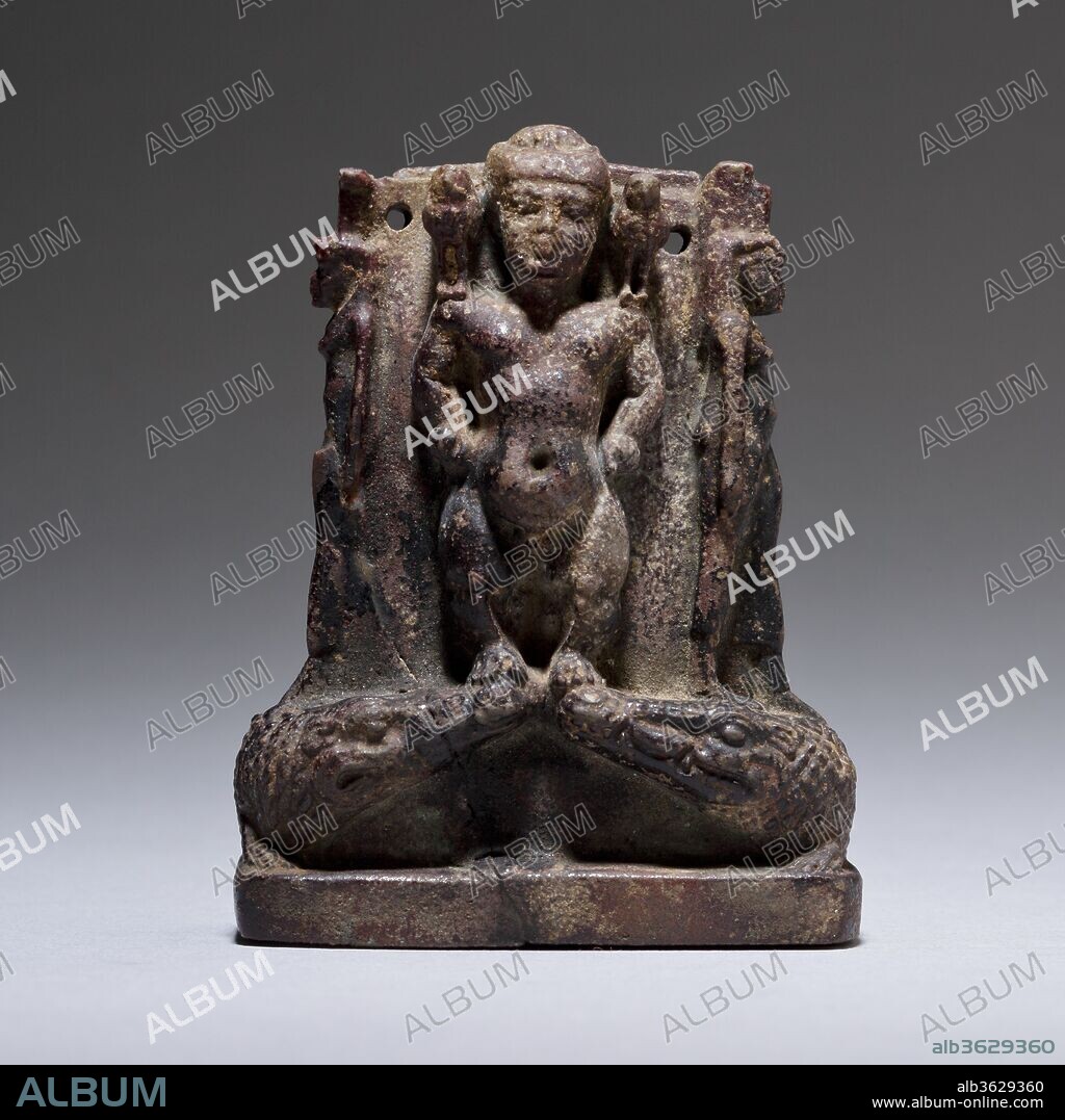 Cippus (magical stela) where Pataikos replaces Horus on the crocodiles and is flanked by Isis and Nephthys. Dimensions: H 7.7 cm (3 1/16 in); w. 5.5 cm (2 3/16 in); d. 2.5 (1 in). Date: ca. 1070-525 BC.
On most cippi or magical stelae, an image of the infant Horus on the front beneath a Bes-image is shown subduing dangerous animals. The Metternich Stela (acc. 50.85) is the largest and most elaborate example of the genre.
This faience cippus is a variant where Pataikos replaces the Horus child and stands on the crocodiles usually trodden by Horus the child. On either shoulder figure Ba birds, Isis and Nephthys stand at either side, and on the back Maat spreads her wings in projection.