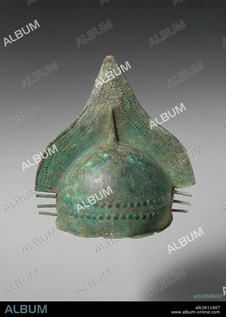 Bronze crested helmet. Culture: Villanovan. Dimensions: Overall: 12 5/8 x 12 1/2in. (32.1 x 31.8cm). Date: 9th century B.C..
Pointed cap and a triangular crest decorated with two rows of small repouseé bosses that follow the crest's contours.