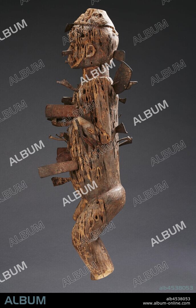 male figure, Bwende people, mid-19th century - 20th century, wood, iron, medicinal substances, 24 x 7 x 7-1/2 in., African Art.