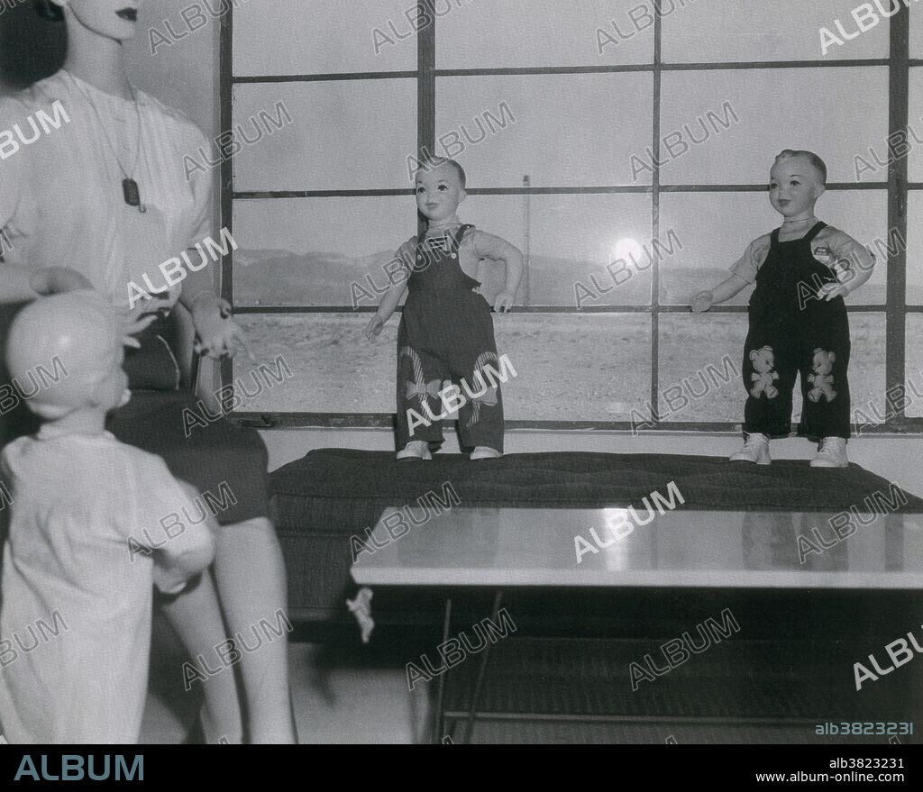 Testing effects of nuclear blast 1955. Operation Teapot was a series of fourteen nuclear test explosions conducted at the Nevada Test Site in the first half of 1955. The aims of the operation were to establish military tactics for ground forces on a nuclear battlefield and to improve the nuclear weapons used for strategic delivery. An assortment of buildings, including residential houses and electrical substations, were constructed at the site nicknamed "Survival Town". The buildings set at varying distances from the blasts to test the impact and effects of the explosions. The homes were populated by 1950's mannequin families, dressed in outfits., and placed in various rooms in the house.