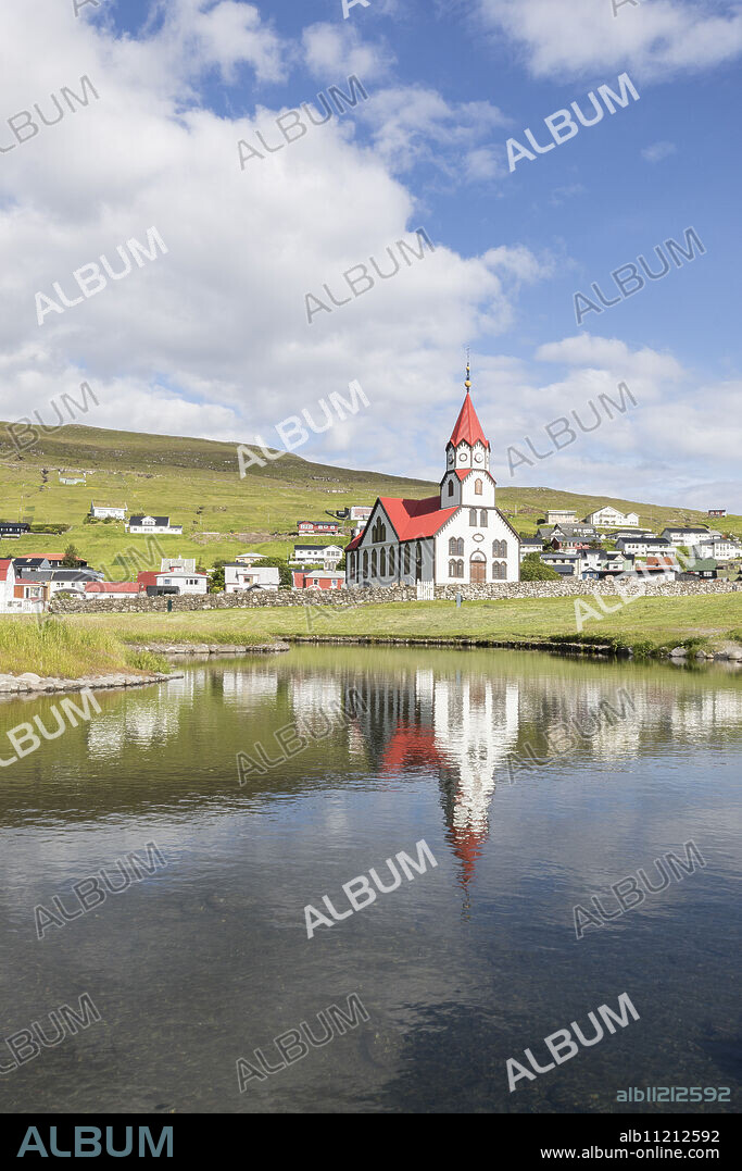 Church of Sandavagur reflected in water, Vagar Island, Faroe Islands, Denmark, Europe.