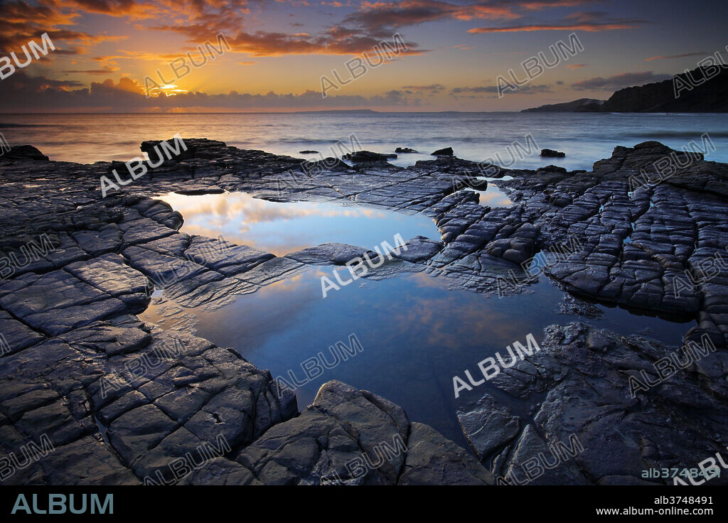 Rockpools on Broad Bench looking towards Gad Cliff and the Isle of Portland, Hobarrow Bay, Jurassic Coast, UNESCO World Heritage Site, Dorset, England, United Kingdom, Europe.