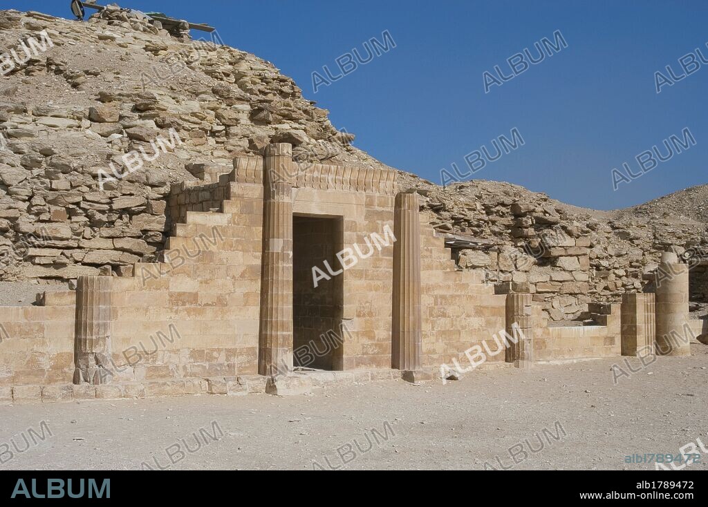 Egypt. Saqqara. Djoser's complex. The South House just east of the pyramid of Djoser. Is a symbolic building decorated with four fluted columns forty feet high, with niches for offerings. Old Kingdom.