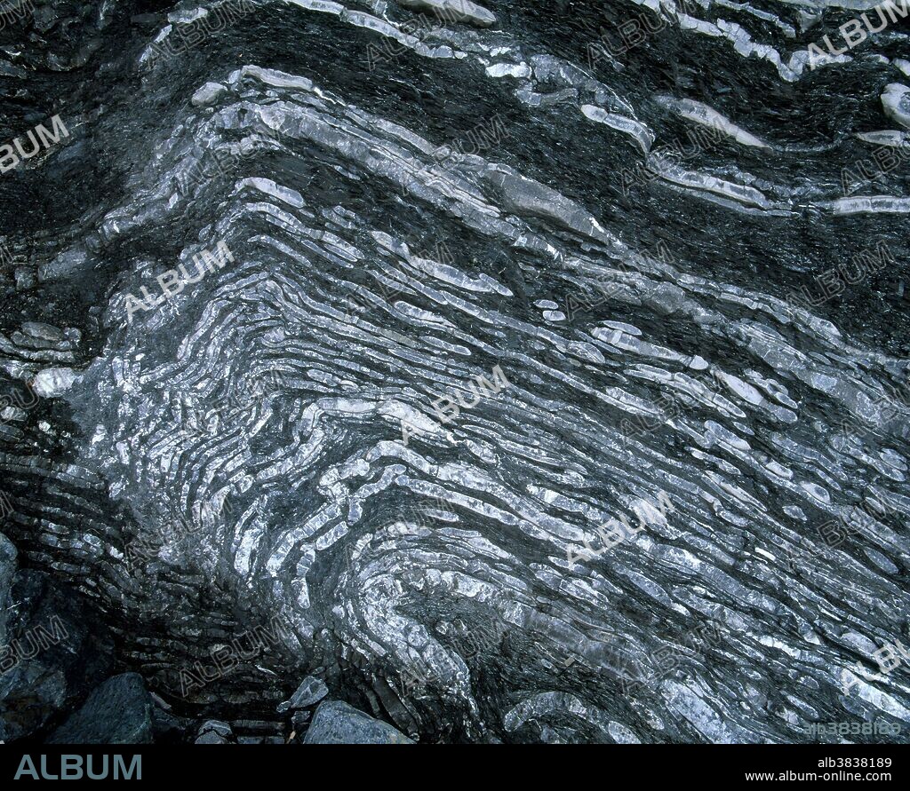 Crushed rocks in a matrix of shale, called melange, formed during the Taconian Orogeny in the Cambrian Period at Lobster Cove Head in Gros Morne National Park, Newfoundland, Canada.