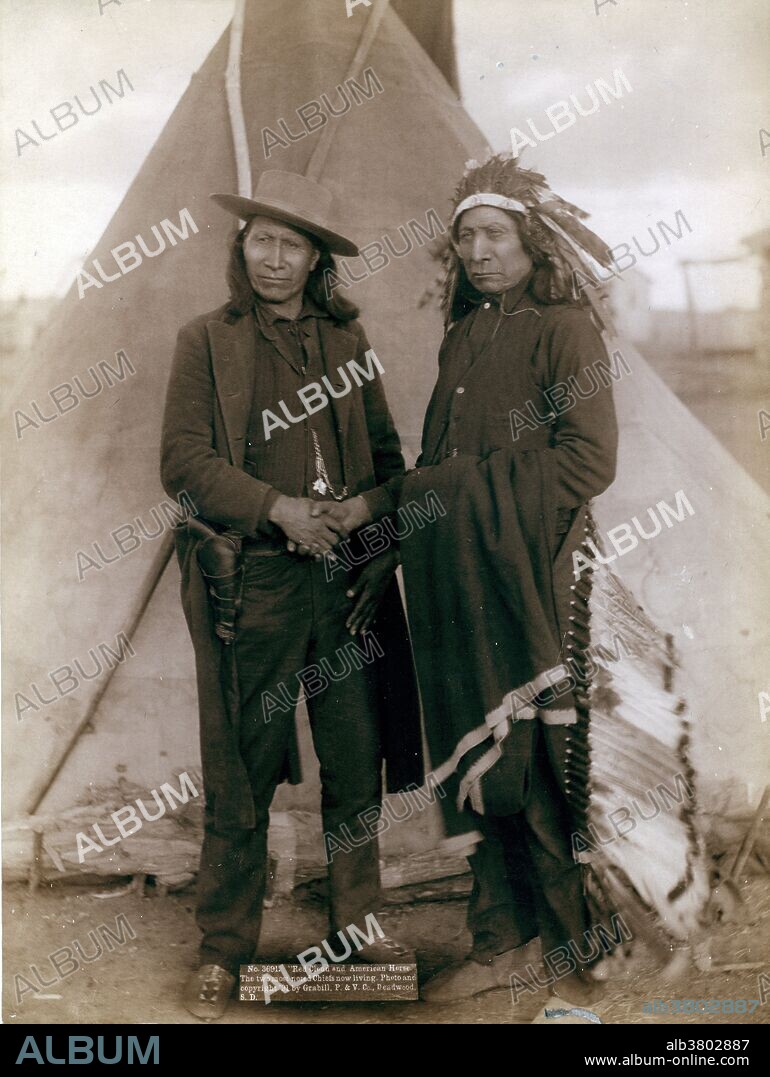 Two Oglala chiefs, American Horse (wearing western clothing and gun-in-holster) and Red Cloud (wearing headdress), shaking hands in front of tipi, probably on or near Pine Ridge Reservation. Photographed by John C.H. Grabill, 1891. American Horse (1840 - December 16, 1908) was an Oglala Lakota chief, statesman, educator and historian. American Horse is notable in American history as a U.S. Army Indian Scout and a progressive Oglala Lakota leader who promoted friendly associations with whites and education for his people. American Horse opposed Crazy Horse during the Great Sioux War of 1876-1877 and the Ghost Dance Movement of 1890, and was a Lakota delegate to Washington. Red Cloud (1822 - December 10, 1909) was a very strong war leader and a chief of the Oglala Lakota. The Oglala Lakota or Oglala Sioux are one of the seven sub-tribes of the Lakota people, who along with the Nakota and Dakota, make up the Great Sioux Nation. He led as a chief from 1868 to 1909. One of the most capable Native American opponents the United States Army faced, he led a successful campaign in 1866-1868 known as Red Cloud's War over control of the Powder River Country in northeastern Wyoming and southern Montana. After signing the Treaty of Fort Laramie (1868), he led his people in the important transition to reservation life.