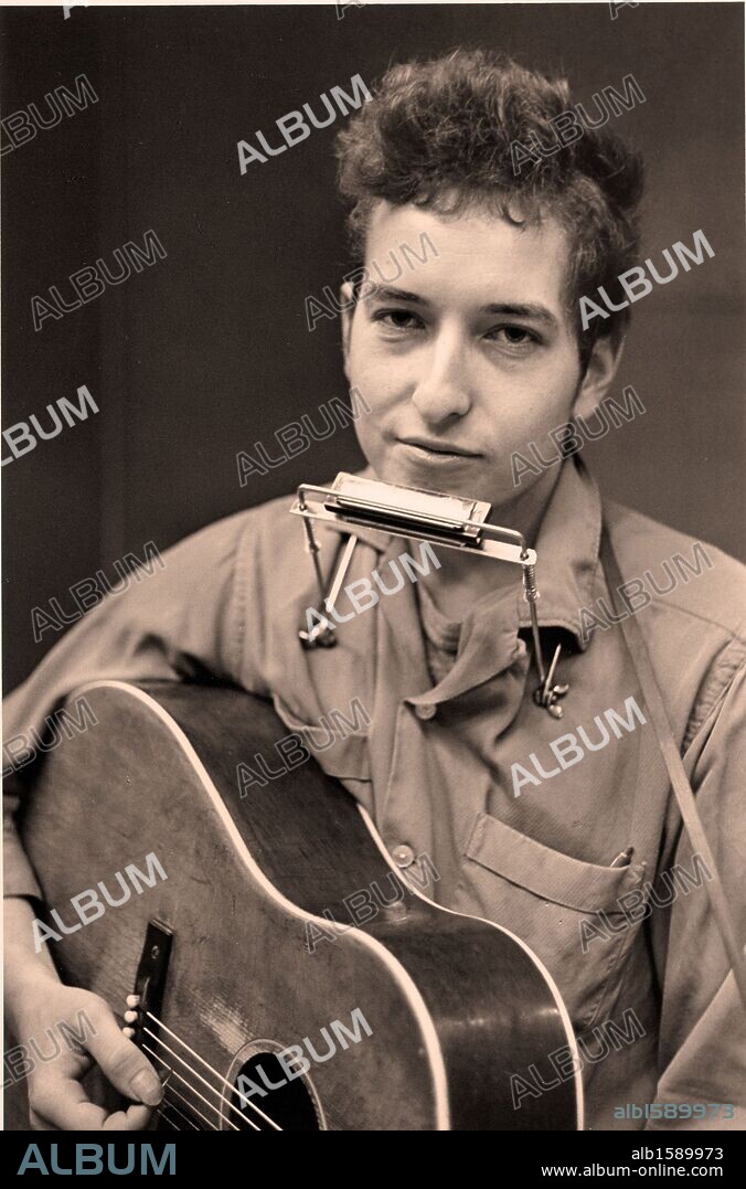 FILE PHOTO - BOB DYLAN, American singer songwriter, poet, folk and rock musician is celebrating his 70th birthday. Dylan sings, plays guitar, harmonica and piano and is considered one of the most influential music makers of the 20th Century. PICTURED - Jan. 19, 2007 - Minneapolis, Minnesota, U.S. - Image of BOB DYLAN with a harmonica around his neck and a guitar in his arms at the Weisman Museum Exhibit 'Journey 1956-1966 - Bob Dylan. 24/05/2011
