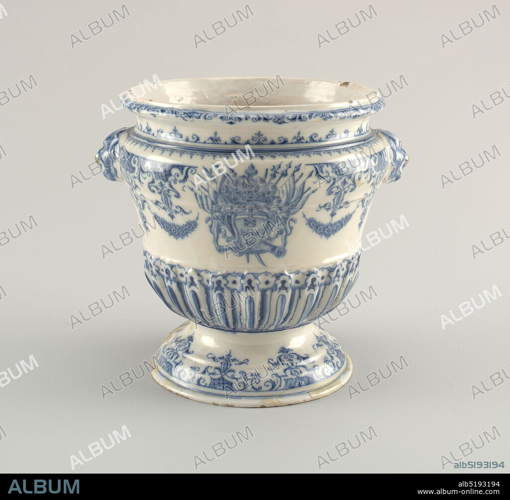 Urn, Tin-glazed earthenware, On molded foot a bell-shaped body with heavy gadrooning on lower part. Flaring neck and mascaroon handles. Underglaze cobalt lambrequin and scroll decoration at neck and foot. Body shows floral swags and a large coat-of-arms with three stag antlers (attires) below crossed keys, crested by five-point crown, helmet and four-de-lis, helbard, flags and smoking cannons. All on vertical hatching indicating the color red (gules)., Rouen, France, ca. 1735, ceramics, Decorative Arts, Urn.