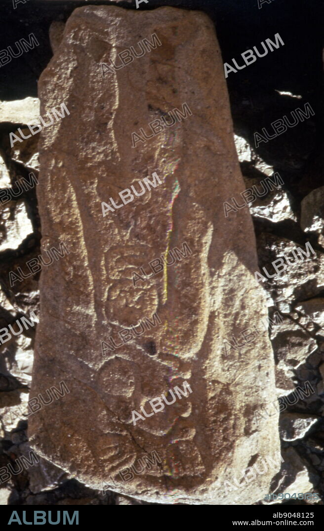 standing figure of one of the "Los Danzantes" a collection of more than 300 bas-reliefs at Monte Alban. Monte Alban, is a large pre-Columbian archaeological site in the Santa Cruz Xoxocotlan Municipality in the southern Mexican state of Oaxaca. Besides being one of the earliest cities of Mesoamerica, Monte Alban's importance stems also from its role as the pre-eminent Zapotec socio-political and economic center for close to a thousand years. Founded toward the end of the Middle Formative period at around 500 BC. One characteristic of Monte Alban is the large number of carved stone monuments one encounters throughout the plaza. The earliest examples are the so-called "Danzantes" (literally, dancers), The figures are said to represent sacrificial victims.