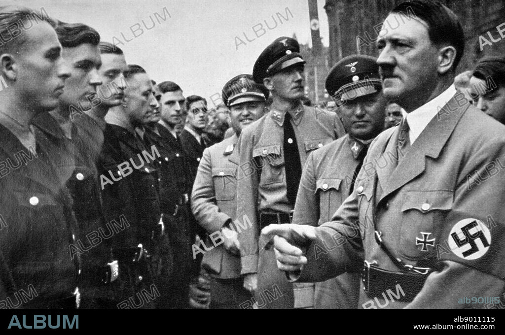 Adolf Hitler with Robert Ley 1890 25 October 1945) greeting young Nazi Labour Movement members 1935. Ley was a senior Nazi politician and head of the German Labour Front from 1933 to 1945. He committed suicide while awaiting trial at Nuremberg for war crimes.
