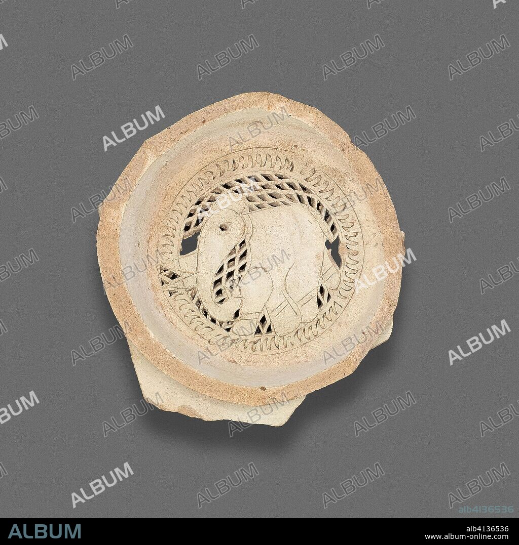 ISLAMIC. Clay filter with design of elephant. Egypt; Fustat. Date: 1000-1200. Dimensions: 2.5 × 7.9 cm (1 × 3 1/8 in.). Earthenware, carved and punched. Origin: Masr al-`Atiqah.