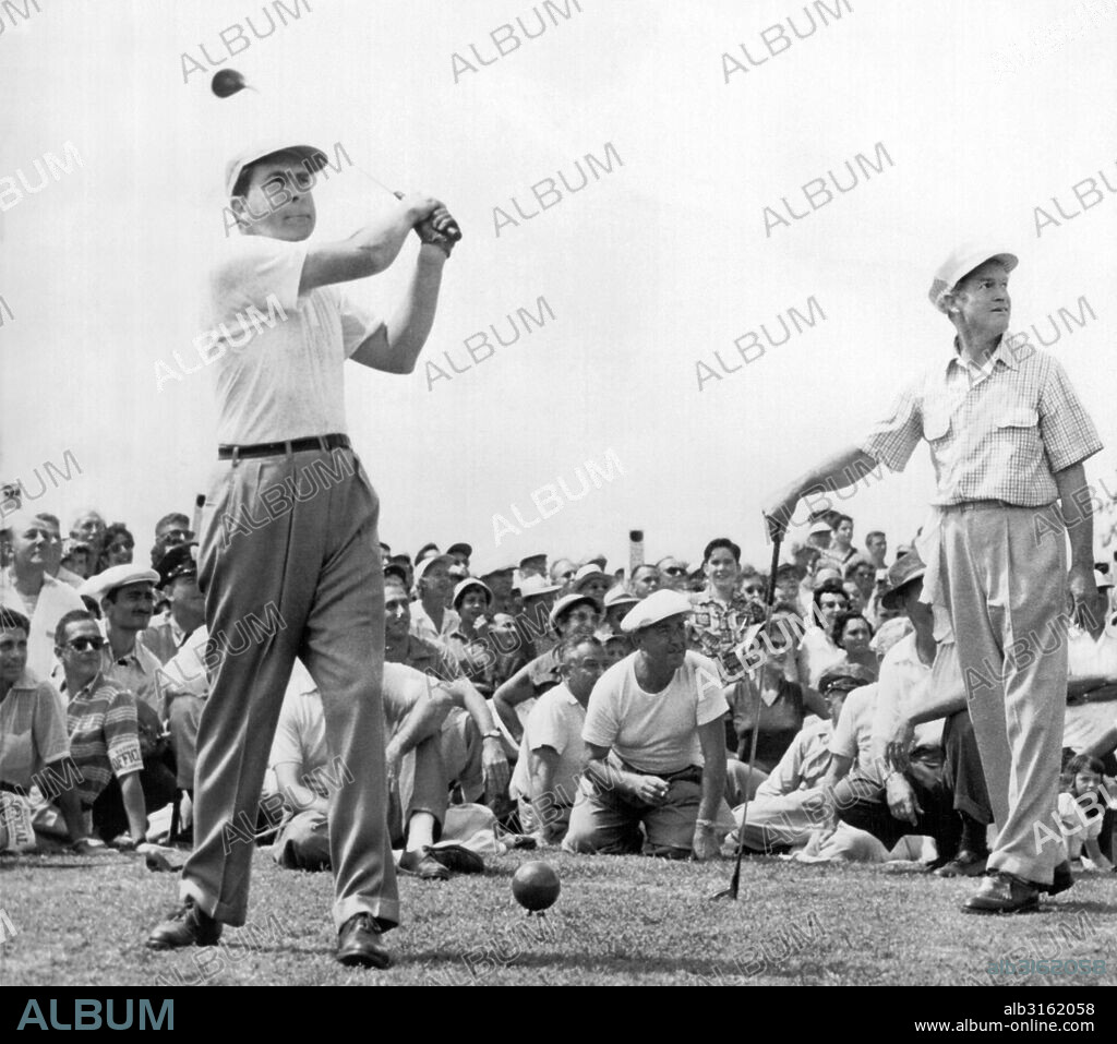 Rockville, Maryland: 1953. Vice-President Richard Nixon tees off at the National Celebrities Open Tournament at the Woodmont Country Club. Bob Hope at right smiles as he watches the ball heading for spectators. Nixon, a newcomer to the sport, twice sent spectators ducking on the first hole.