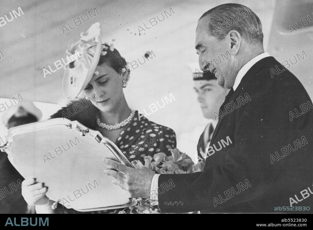 H.R.H. The Duchess of Kent Re-Names The Cruiser Amphion -- H.M.A.S. "Perth" on its transfer to the Royal Australian Navy, at Portsmouth Dockyard.The Rt. Hon. S.M. Bruce (High Commissioner for Australia) presents a silver salver to the Duchess of Kent after the ceremony as a souvenir. July 10, 1939. (Photo by Sport & General Press Agency, Limited).