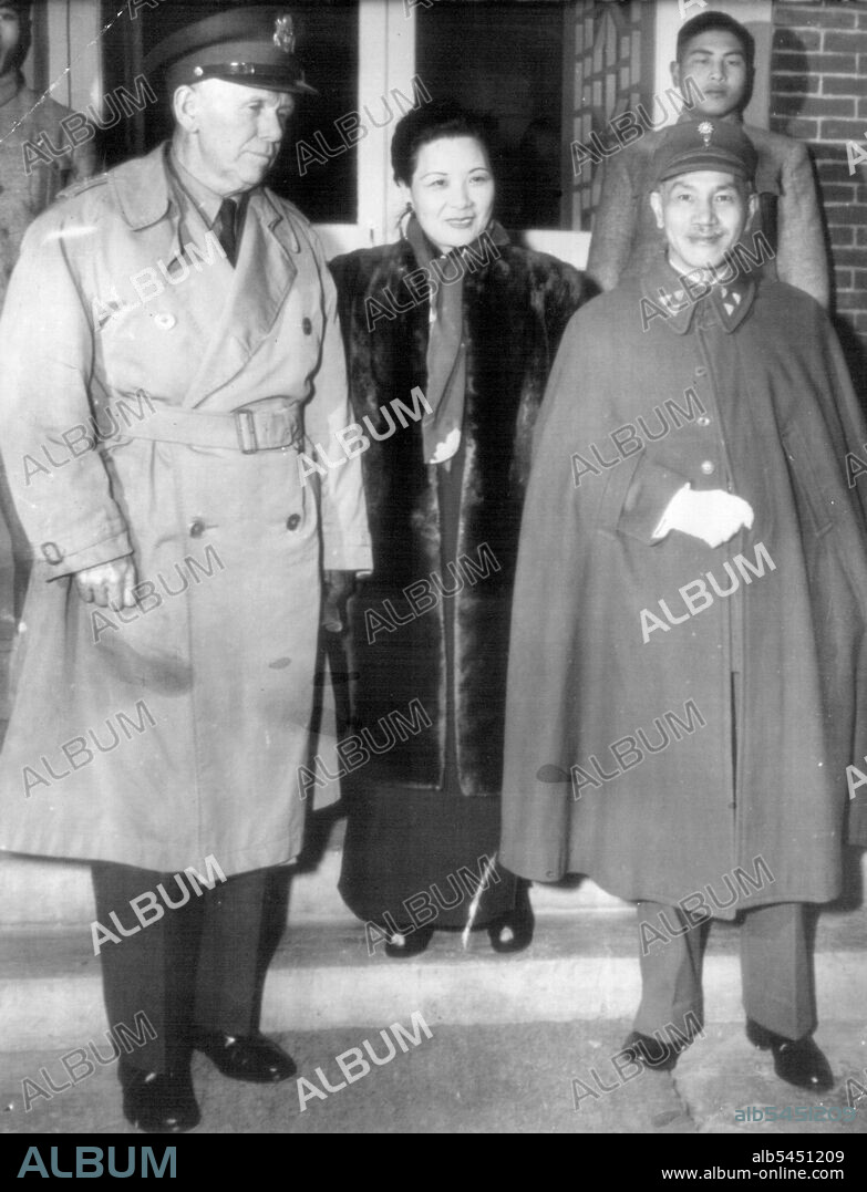 Marshall Visits Chiangs ***** - Gen. George C. Marshall (left), special envoy to China, poses on the steps of the Nanking residence of Generalissimo, Chiang Kai-Shek with his host, the Generalissimo (left) and Madame Chiang (center), shortly after his arrival at Nanking. December 28, 1945. (Photo by AP Wirephoto).