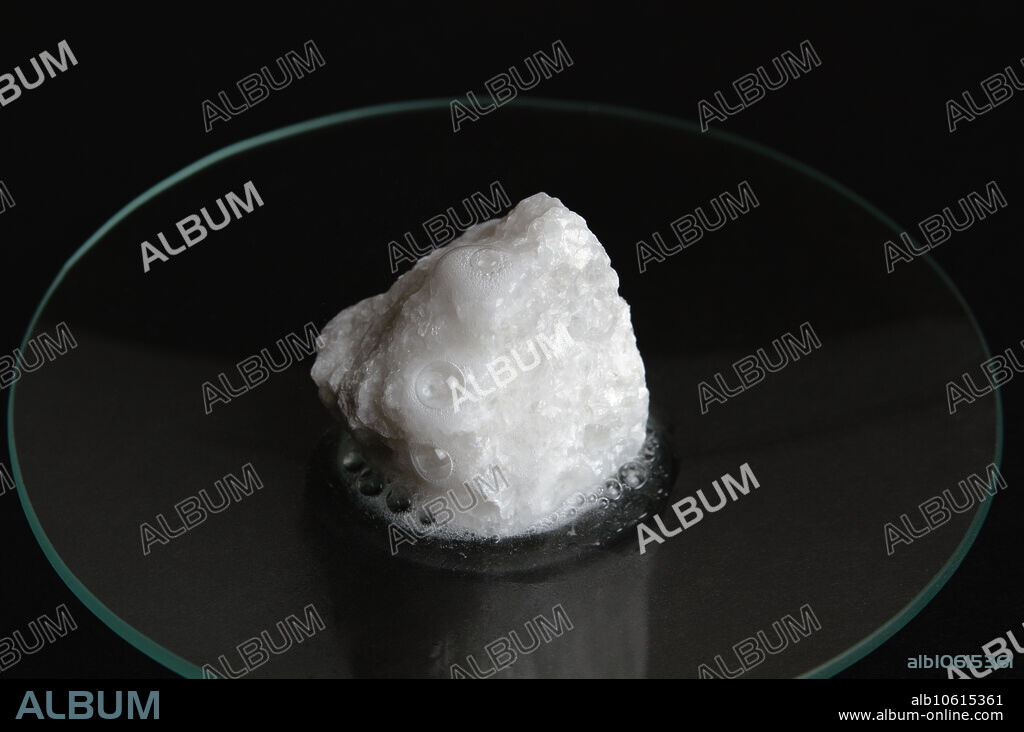 Marble reacting with acid. When a few drops of 1M of hydrochloric acid are poured on a marble specimen, bubbles are produced. Marble contains calcium carbonate that reacts with hydrochloric acid to produce carbon dioxide bubbles: CaCO3 + HCl -> CaCl2 + H2O + CO2. This is the mechanism by which acid rain erodes marble statues and structures.