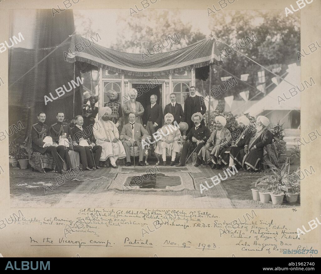 Photograph of a group including Lord Curzon and the Maharaja of Patiala. In the Viceroy's camp, Patiala, Nov 9th 1903. Sitters named; from left: 'Capt Keighley, ADC; Col Baring, mil sec; Mr Louis Dane, For secretary; Sir Ranbir Singh, KCSI, Kanwar Sahib of Patiala; Col Pretum Singh, C in C of Patiala troops; Col Abdul Majid Khan, For minister of Patiala; Lord Curzon; F.W. Latimer; The Maharaja; Mr Bolster, Pers assistant to Maj Dunlop Smith; Mr Sells, MR's Tutor; J.R.D.S. [Dunlop Smith]; Sirdar Gurmukh Singh, Pres, Council of Regency, Patiala; Khalifa Mahomed Hussain, Council of Regency, Patiala; Lala Bugwan Das, Council of Regency, Patiala'. Dunlop Smith collection. India; Patiala; Punjab; Punjab (India); 9 Nov 1903. Source: Photo 355/2/(96).