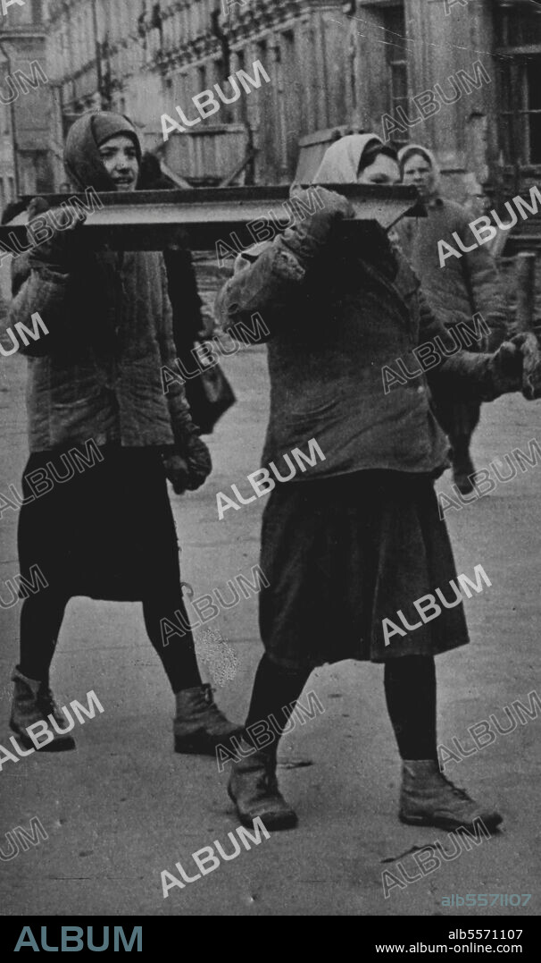 The Women Builders Of Moscow -- Two Russian women carry a heavy steel girder which will form part of the Frame of a building. Women of the Soviet Union literally pull their weight with the menfolk in rez Building The war-ravaged cities. Housing a problem facing all European capitals,claims many women Labourers in the Union these pictures show women assisting in house building in Moscow, Near the *****. April 30, 1947. (Photo by Associated Press Photo).