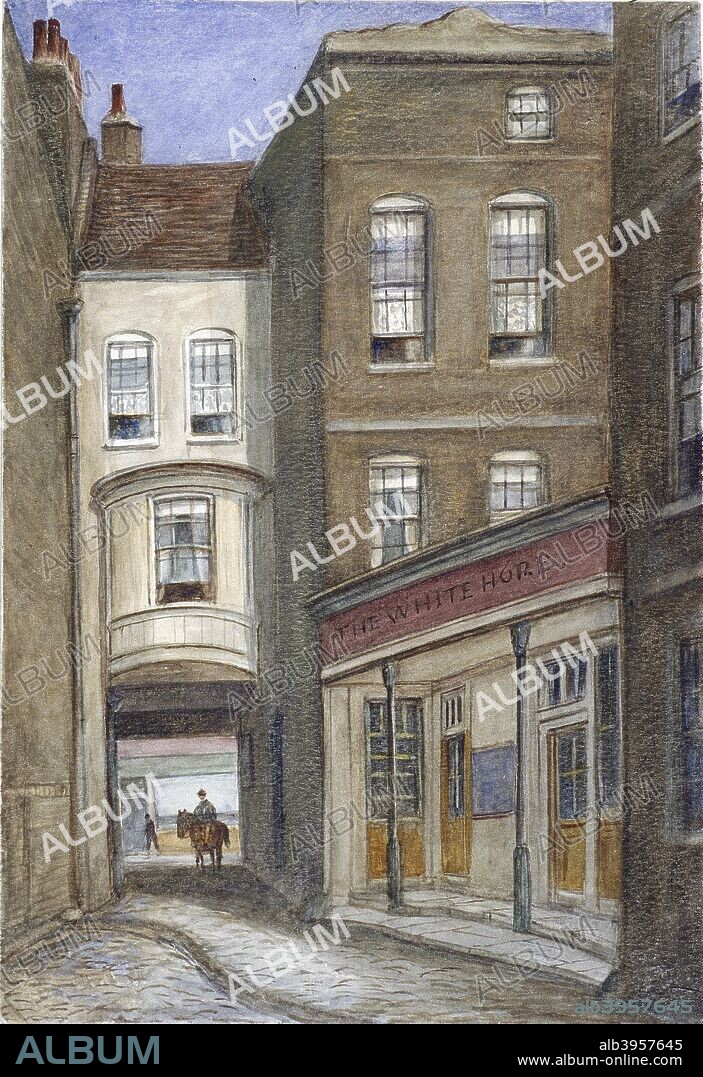 White Horse Inn, Fetter Lane, London, 1870. View of the White Horse Inn on Fetter Lane, with an open drain in the foreground, and a figure on horseback seen through the entrance.