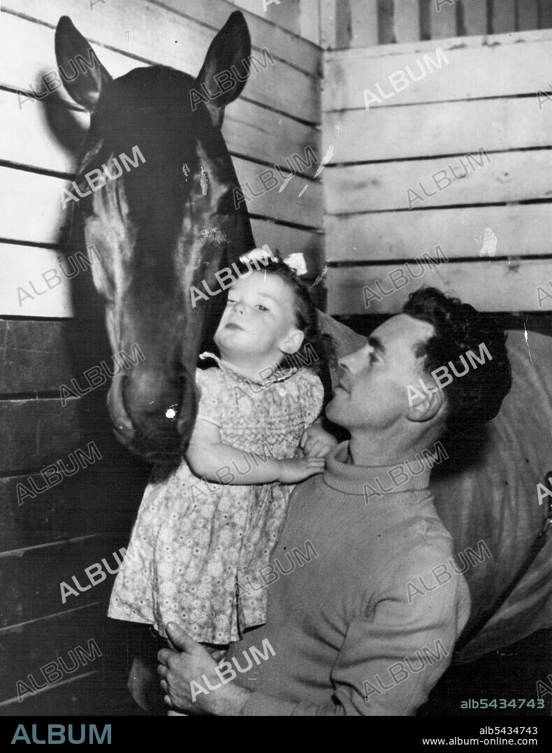 Bob Sinclair introduces two-year-old Vicki Sinclair to Wodalla at Flemington, where a constant guard is being kept on the horse, a prominent Cup candidate. November 2, 1953.