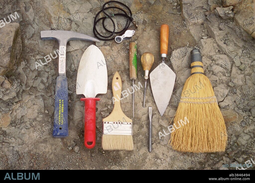 A display of the common tools used to excavate dinosaur fossils. These include a rock hammer, trowel, paintbrush (to remove dust) an ice pick, a cement trowel, a hand brush, and a loupe.