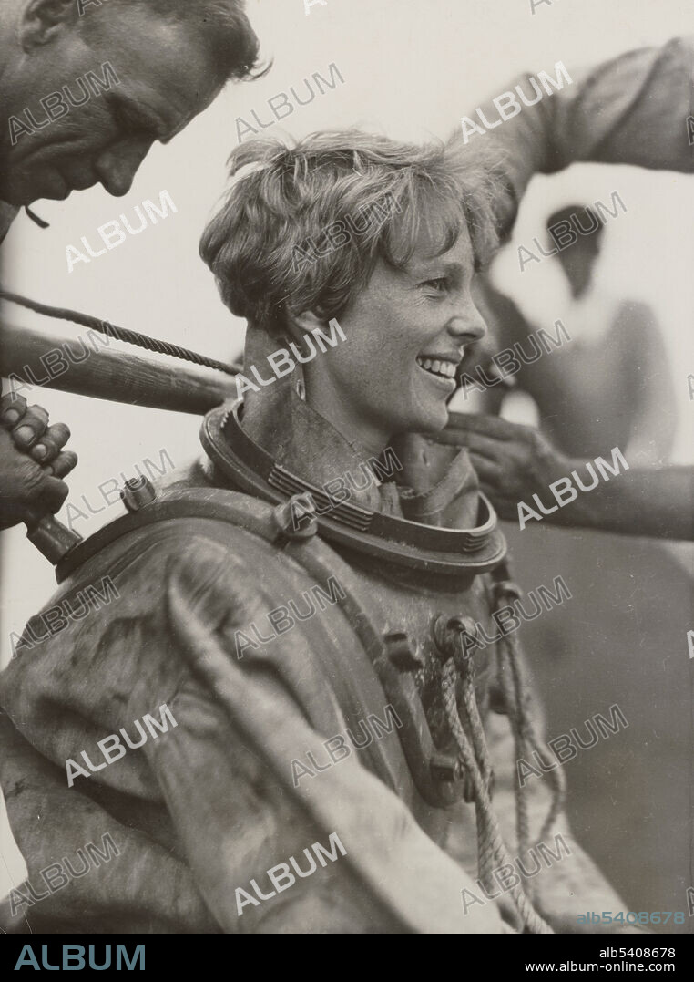 Earhart deep sea diving off Block Island. Amelia Earhart (1897 - disappeared 1937) was an American aviation pioneer and author. She was the first woman aviator to fly solo across the Atlantic Ocean. She set many other records and wrote best-selling books about her flying experiences. She was a member of the NWP and an early supporter of the ERA. Men unidentified, U.S. Information Services, July 25, 1929.