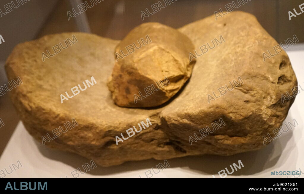 Saddle quern with rubbing stone used for grinding grain. From Wales. Dated 6th Century BC.