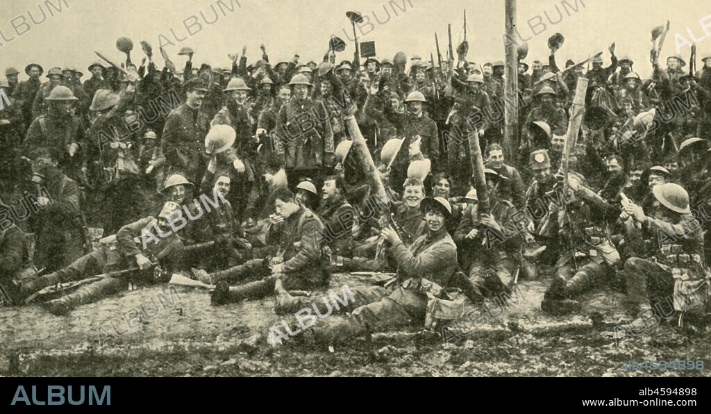 British soldiers after the Battle of St Eloi, Flanders, First World War, 27 March 1916, (c1920). 'Happy Warriors: officers and men of the Northumberland Fusiliers - the "Fighting Fifth" - photographed with their trophies immediately after their successful advance'. The 9th Brigade, including 1st Battalion The Northumberland Fusiliers, attacked heavily defended positions around St Eloi, three miles south of Ypres. From "The Great World War: A History", Volume V, edited by Frank A Mumby. [The Gresham Publishing Company Ltd, London, c1920].