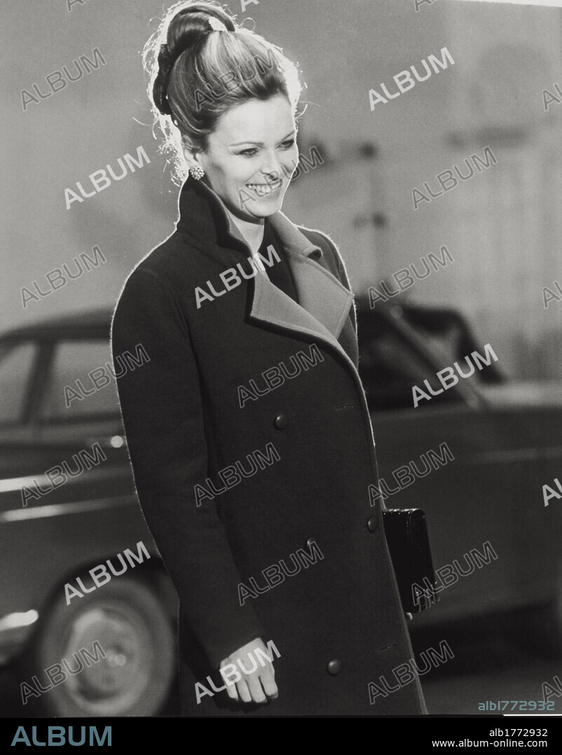 Portrait of a smiling Lucia Bosè. The Italian actress Lucia Bosè is photographed in a garage, during the shooting of  'So long Gulliver' ('Ciao Gulliver') directed by Carlo Tuzii. Italy, 1970.