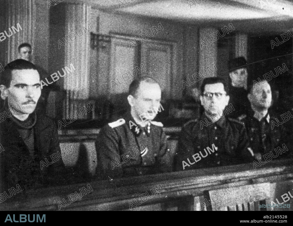 World war 2, december 15, 1943, still from a film on the kharkov trial produced by artkino, the four defendants at the kharkov trial- (l to r) russian traitor mikhail bulanov, hans ritz, reinhard retzlaw, and wilhelm langheld.