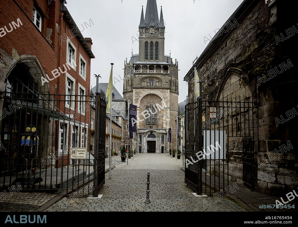 Aachen Cathedral, Aachen Germany June 2018. Aachen Cathedral or Aachen Dom. Aachen Cathedral, Aachener Dom, traditionally called in English the Cathedral of Aix-la-Chapelle, is a Roman Catholic church in Aachen, western Germany, and the see of the Roman Catholic Diocese of Aachen. It is one of the oldest cathedrals in Europe and was constructed by order of the emperor Charlemagne, who was buried there after his death in 814. For 595 years, from 936 to 1531, the Palatine Chapel, heart of the cathedral, was the church of coronation for thirty-one German kings and twelve queens. The church has been the mother church of the Diocese of Aachen since 1802.