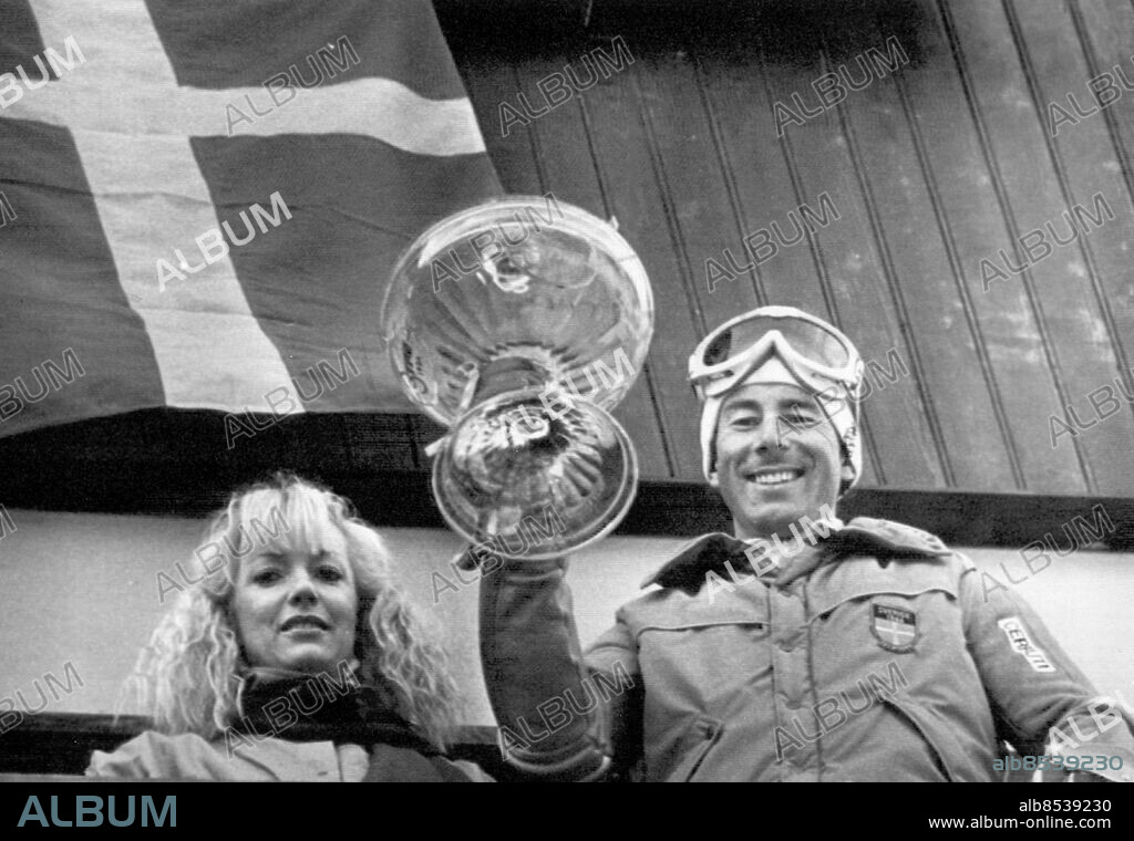 Madonna di Campiglio 1983-12-21. En leende Ingemar Stenmark med sin Ann (Uvhagen) och segerbucklan sedan han tagit sin femte seger i Madonna di Campiglio.. Foto: Erich Stering / DN / TT / Kod: 57. ** SvD OUT **.