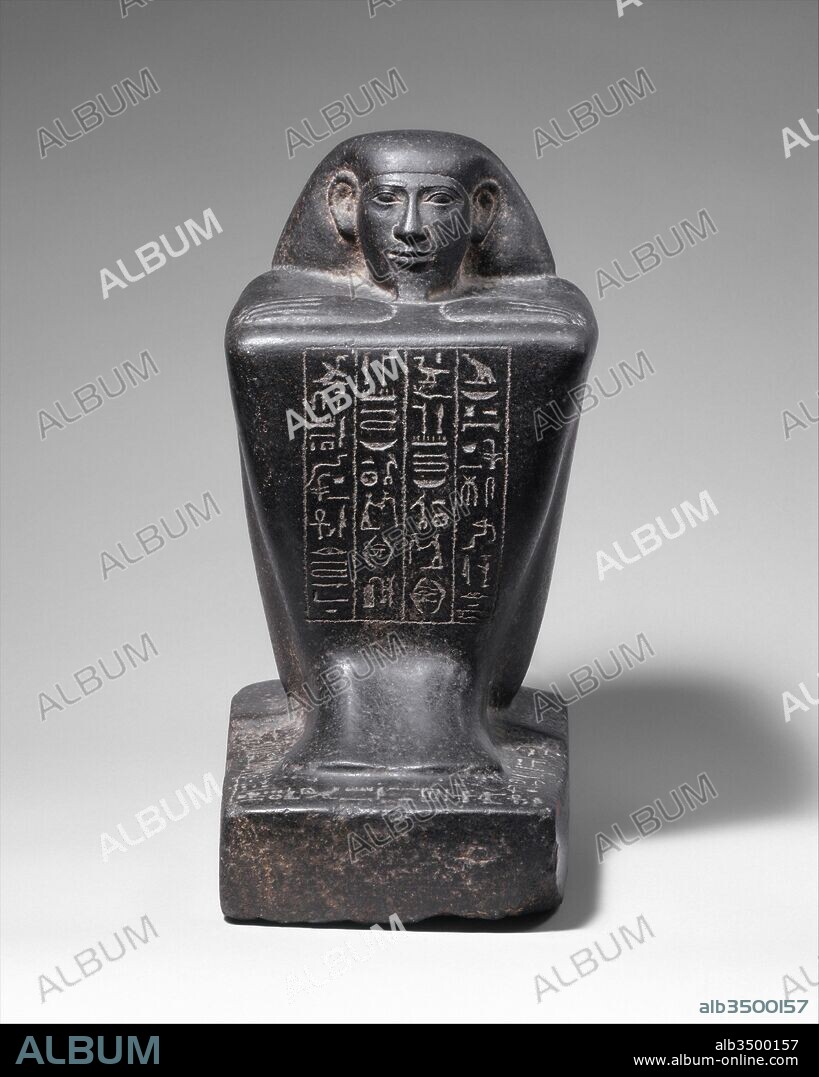 Block Statue of a Prophet of Montu and Scribe Djedkhonsuefankh, son of Khonsumes and Taat, Late Period, Kushite–Saite, Dynasty 25–26, 690–610 B.C., From Egypt; Made for Upper Egypt, Thebes, Luxor, Gabbro, h. 30.7 cm (12 1/16 in), In the late 25th dynasty and early 26th dynasty the austere beauty of the block statue form, here particularly enhanced by the hard gleam of dark surfaces, was greatly appreciated. The form puts a strong emphasis on the face and compliments the often stern or blunt countenances favored at the time.