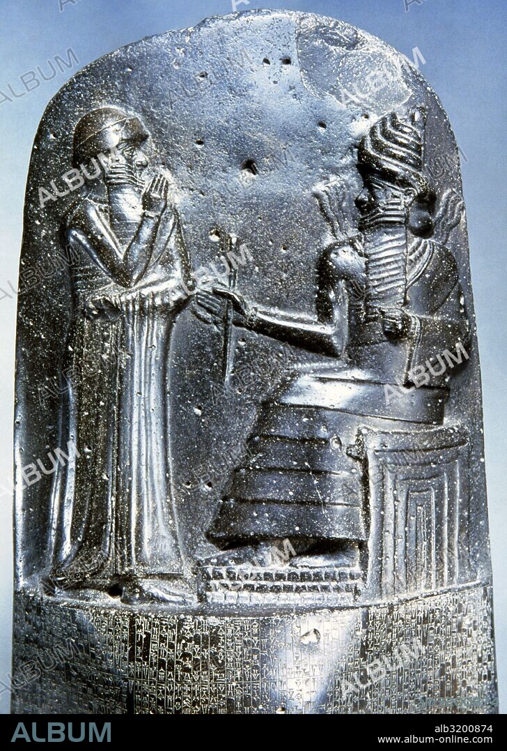 Law Code of Hammurabi, king of Babylon. Basalt. 18th century BC. Detail relief: Hammurabi (standing) depicted as receiving his royal insignia from Shamash, god of justice. Louvre Mueum. Paris, France.