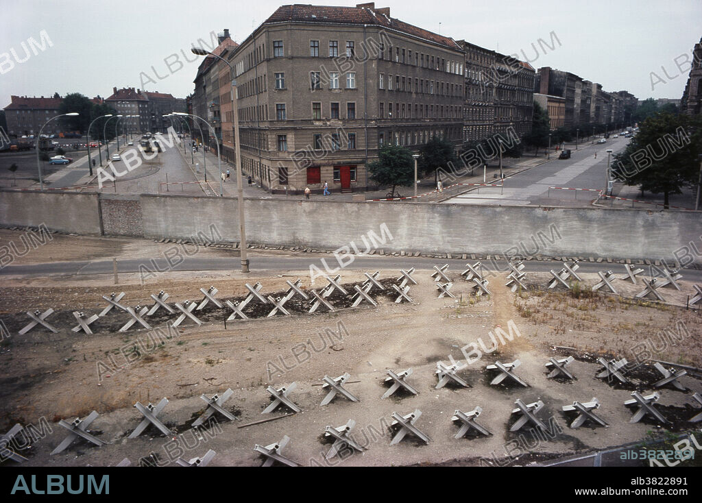 Editorial Use Only . The Berlin Wall at Bernauer Street, West Berlin, Germany, 1970s. The German Democratic Republic (GDR, East Germany) began construction on the Berlin Wall on 13 August 1961. It completely cut off West Berlin from surrounding East Germany and from East Berlin. It was destroyed in 1989 and 1990; German reunification formally concluded on 3 October 1990.
