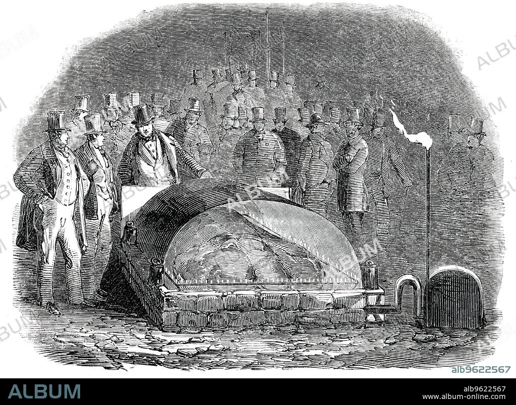 Roasting the Baron of Beef by Gas, in the Castle-Yard, Exeter, [Devon], 1850. Event during the annual meeting and exhibition of the Royal Agricultural Society. 'The most novel, if not the most interesting, sight was that of cooking the baron of beef in the Castle-yard, under the inspection of M. Soyer. In the centre of the yard a hole was dug, and lined with perforated pipes, from which proceeded an innumerable quantity of small jets of gas; when the beef was deposited in this hollow, a similar apparatus of perforated pipes closed over the top, so that the meat was enveloped in a continued sheet of fire'. From "Illustrated London News", 1850.