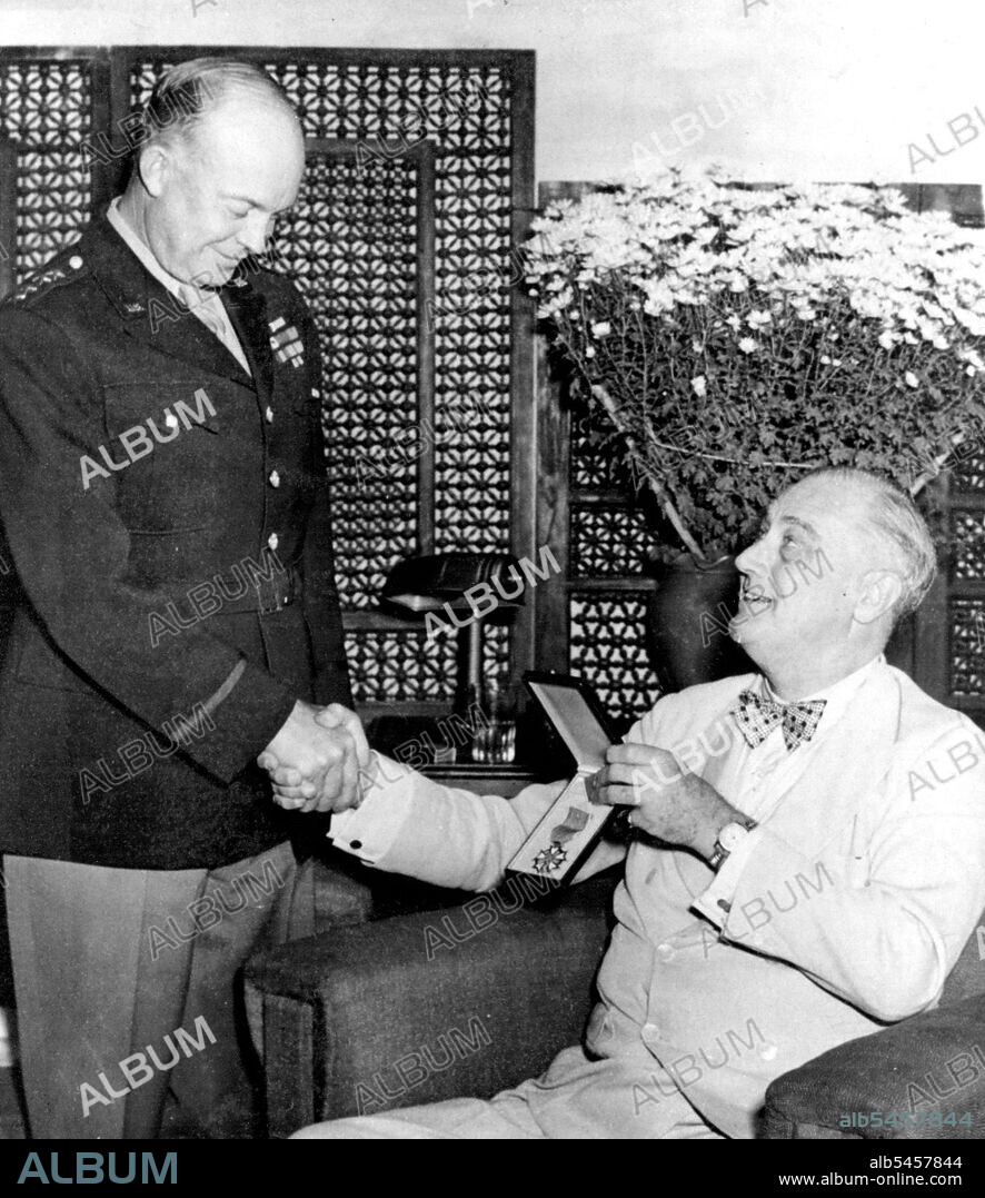 Roosevelt Presidents Legion of Merit to Eisenhower President Roosevelt, wearing Polka dot tie awards the Legion of merit to General Dwight Eisenhower during his trip to the recent conferences in Cairo and Teheran. December 5, 1943. (Photo by Air Force Photo).