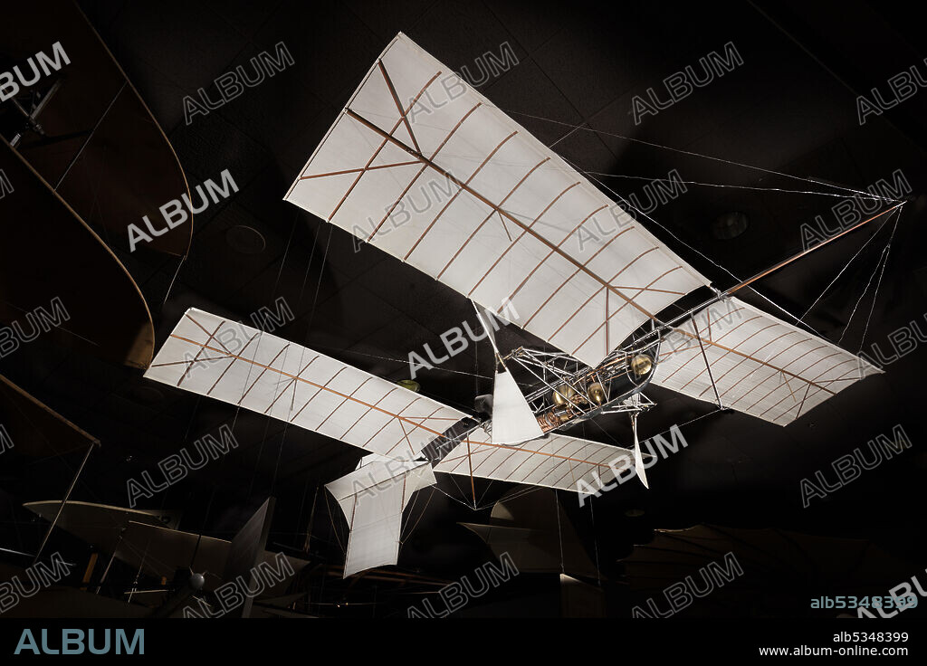 Model of the unpiloted, tandem-wing experimental aircraft built and tested by Samuel P. Langley. One one-horsepower, one-cylinder steam engine turning two pusher propellers via geared transmission system. Silk covering. Natural fabric finish; no sealant or paint of any kind. Samuel Pierpont Langley became the third Secretary of the Smithsonian Institution in 1887. In 1891, he began experiments with large, tandem-winged models powered by small steam and gasoline engines he called aerodromes. After several failures with designs that were too fragile and under-powered to sustain themselves, Langley had his first genuine success on May 6, 1896, with his Aerodrome Number 5. It made the world's first successful flight of an unpiloted, engine-driven, heavier-than-air craft of substantial size. It was launched from a spring-actuated catapult mounted on top of a houseboat on the Potomac River near Quantico, Virginia. Two flights were made on May 6, one of 1,005 m (3,300 ft) and a second of 700 m (2,300 ft), at a speed of approximately 40 kph (25 mph). On both occasions, the Aerodrome Number 5 landed in the water, as planned, because, in order to save weight, it was not equipped with landing gear.
